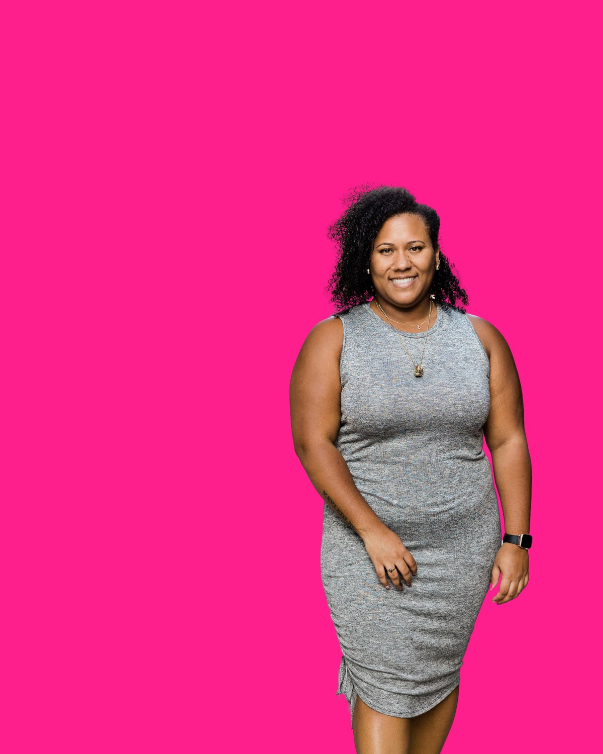 A practitioner in red with a thoughtful, hand-to-chin pose against a hot pink background