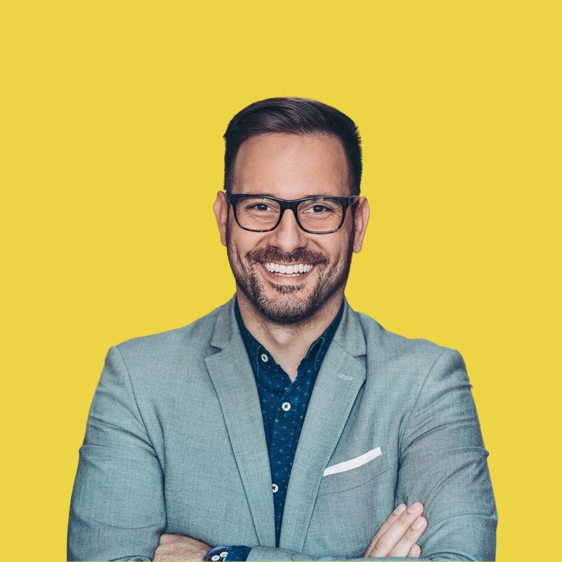 A warm leader in a pale shirt with an open, approachable expression against a ripe lemon background