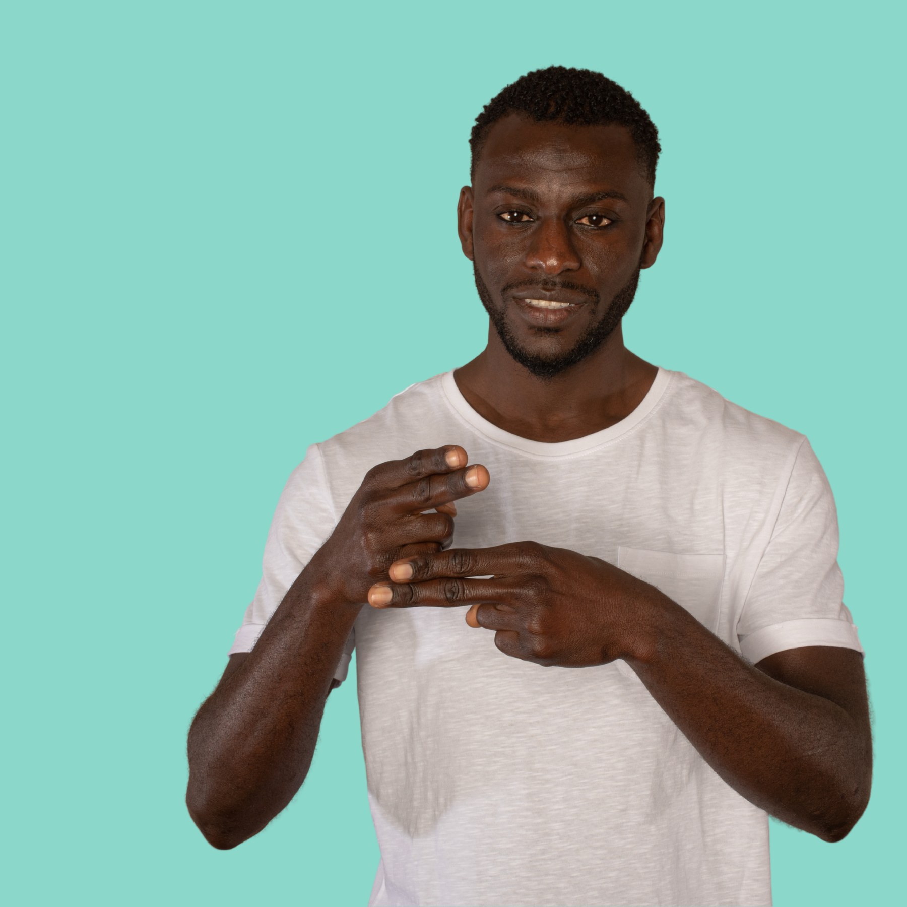A practitioner in a white t-shirt gesturing mid-conversation, engaged and animated, against a Neptune background