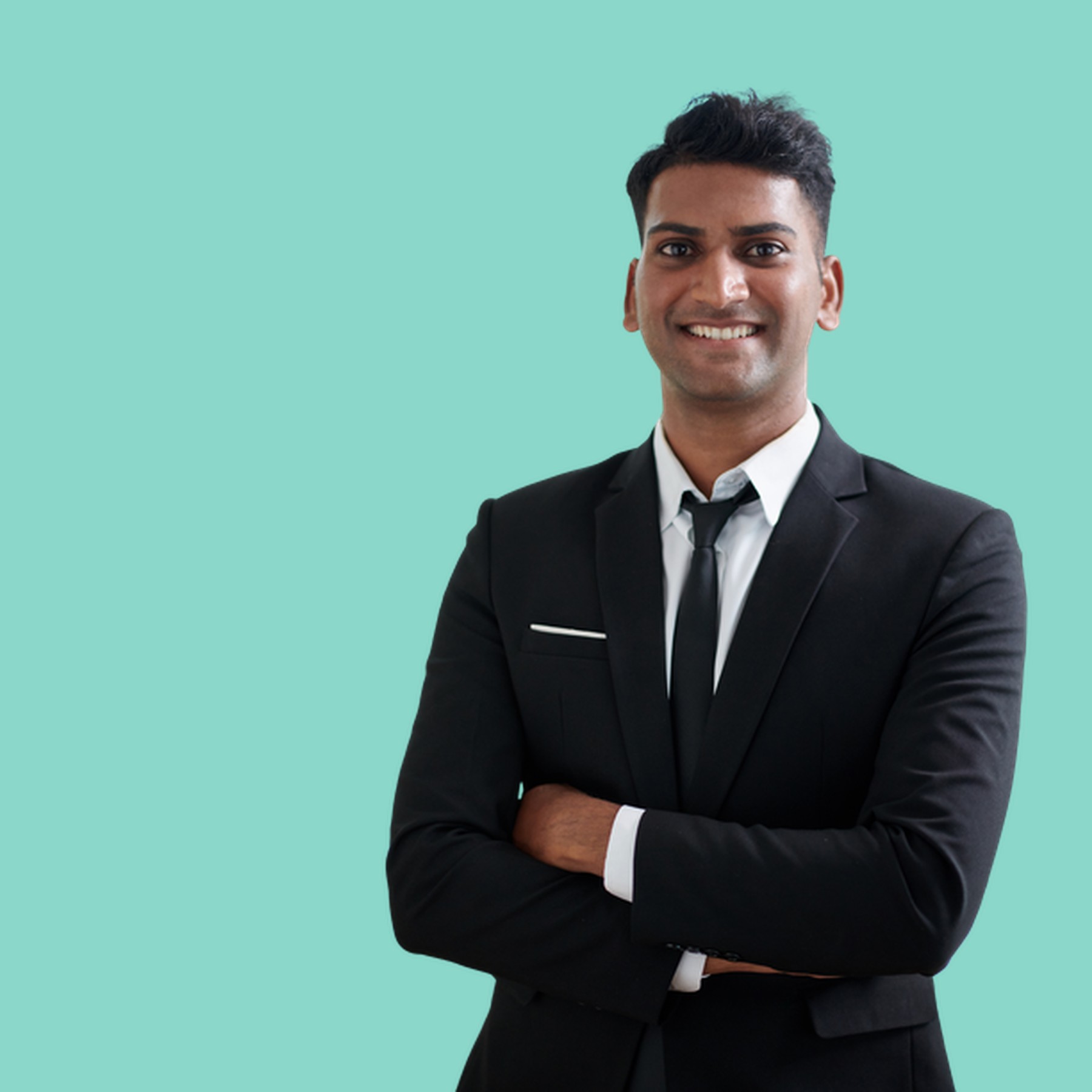 A practitioner in a dark suit with a confident, approachable presence against a teal background