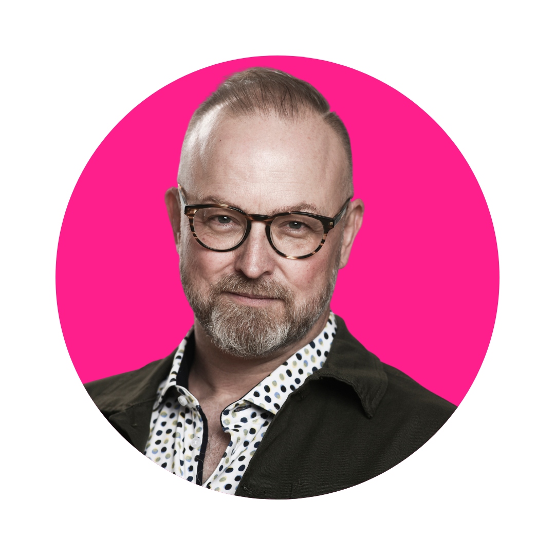 Headshot of Michael Bach against a hot pink background