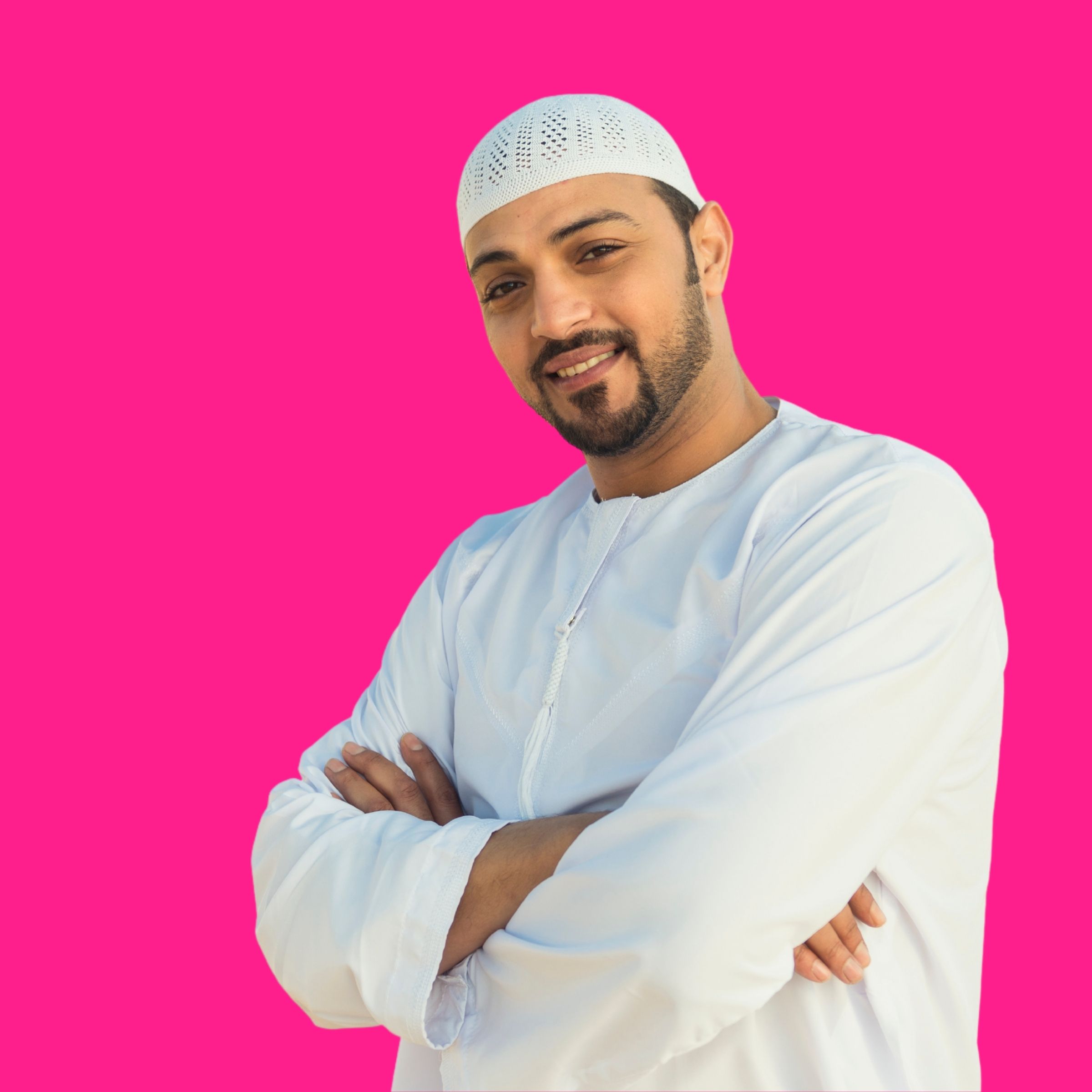 A practitioner smiling and working against a hot pink background